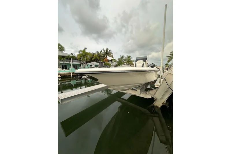  Yacht Photos Pics 2021 ShearWater 270 Carolina Flare boat docked near palm trees and waterfront homes.