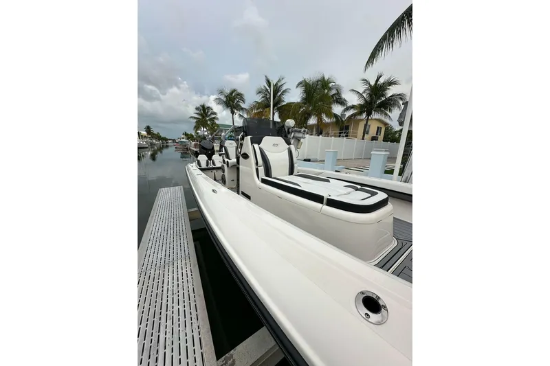 Yacht Photos Pics 2021 ShearWater 270 Carolina Flare boat docked, surrounded by palm trees and waterfront homes.