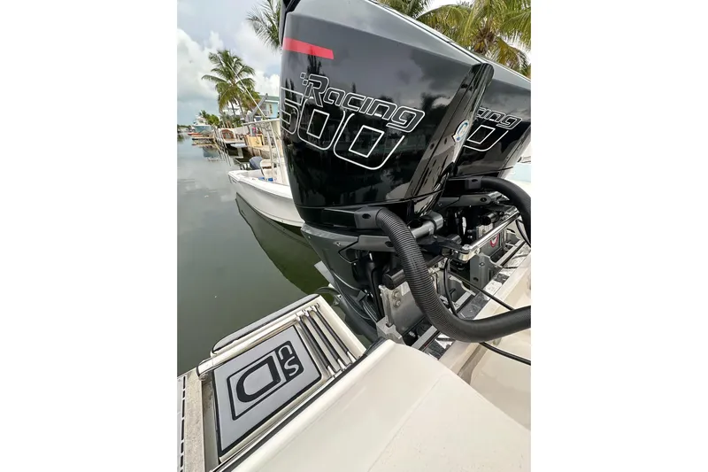  Yacht Photos Pics 2021 ShearWater 270 Carolina Flare with powerful Racing 500 engines docked by palm trees.