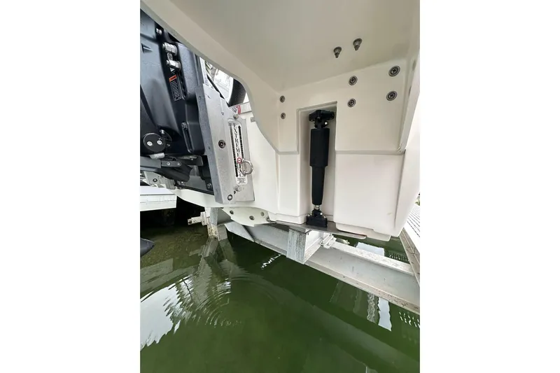  Yacht Photos Pics 2021 ShearWater 270 Carolina Flare boat engine detail on lift above water.