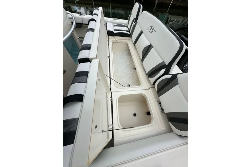  Yacht Photos Pics 2021 ShearWater 270 Carolina Flare boat with open storage compartments and cushioned seating.