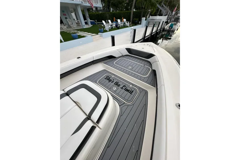  Yacht Photos Pics 2021 ShearWater 270 Carolina Flare boat with custom deck, docked near a modern house.