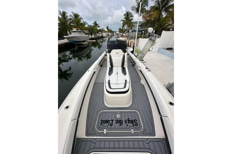  Yacht Photos Pics 2021 ShearWater 270 Carolina Flare boat docked by palm trees.
