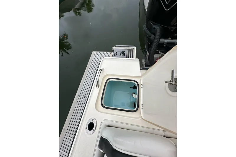  Yacht Photos Pics 2021 ShearWater 270 Carolina Flare boat with open hatch and visible engine.