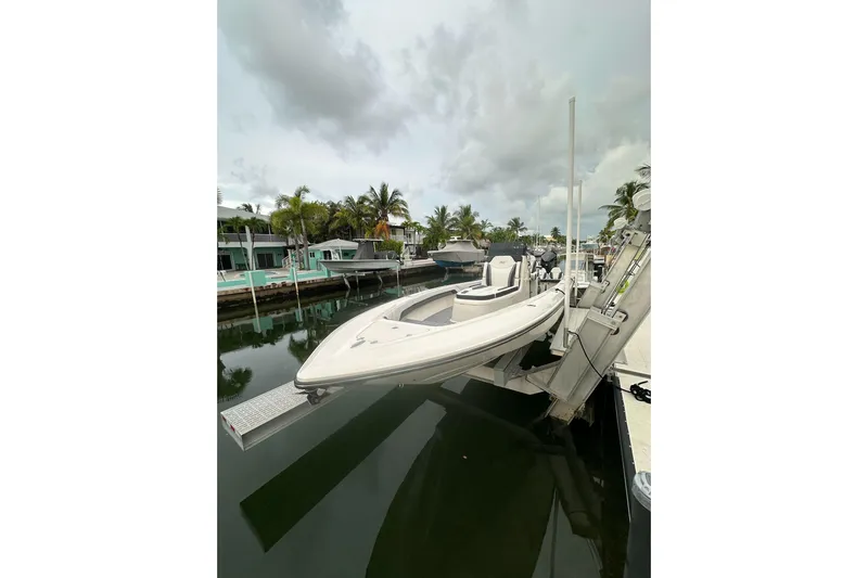  Yacht Photos Pics 2021 ShearWater 270 Carolina Flare boat docked in a tropical marina setting.