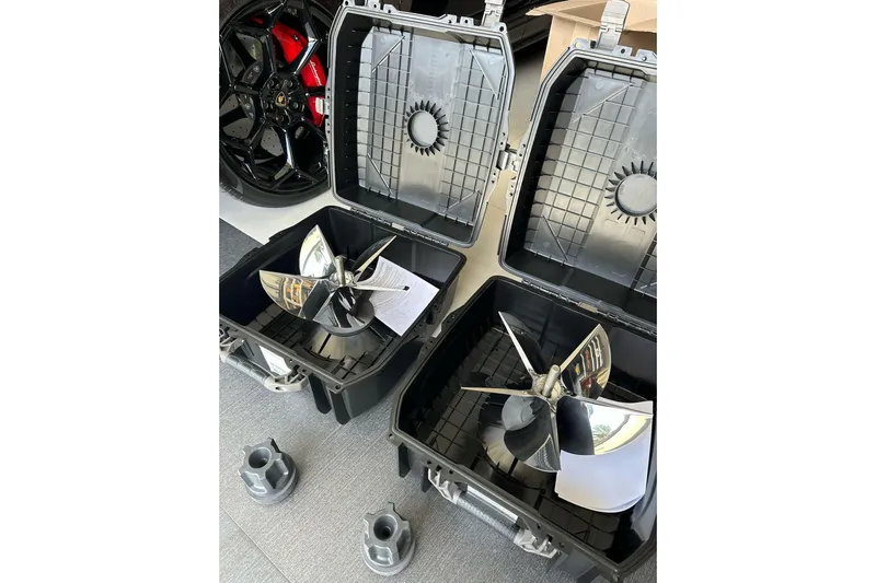  Yacht Photos Pics Propellers in cases for 2021 ShearWater 270 Carolina Flare boat, with car wheel in background.