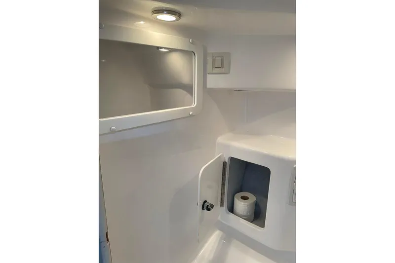  Yacht Photos Pics 2001 Fountain 35 Lightning boat interior with storage compartment and toilet paper.
