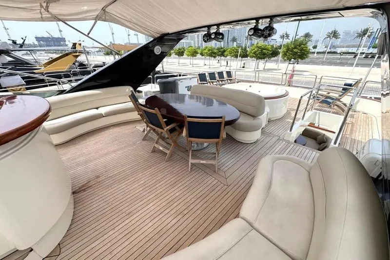  Yacht Photos Pics Luxurious 2004 Azimut 100 Jumbo yacht deck with elegant seating and dining area.