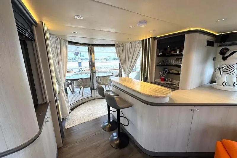  Yacht Photos Pics Luxurious interior of 2004 Azimut 100 Jumbo yacht with bar and seating area.