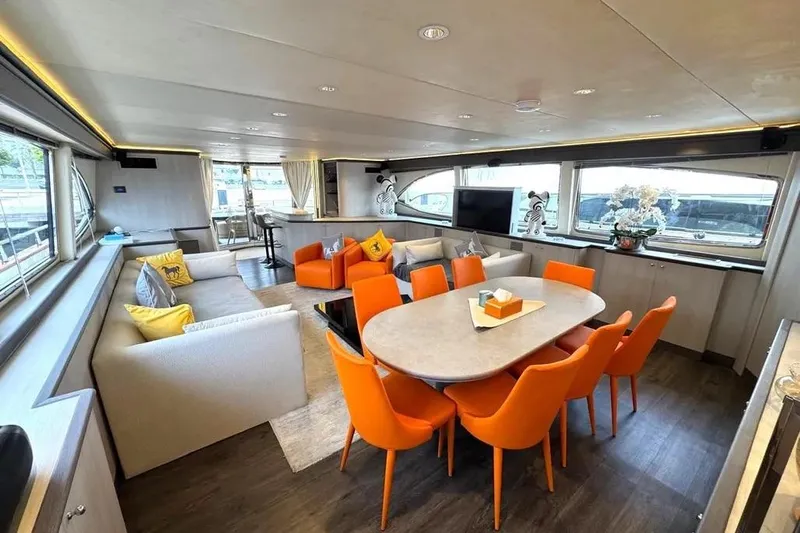  Yacht Photos Pics Luxurious interior of 2004 Azimut 100 Jumbo yacht with vibrant orange seating and modern decor.