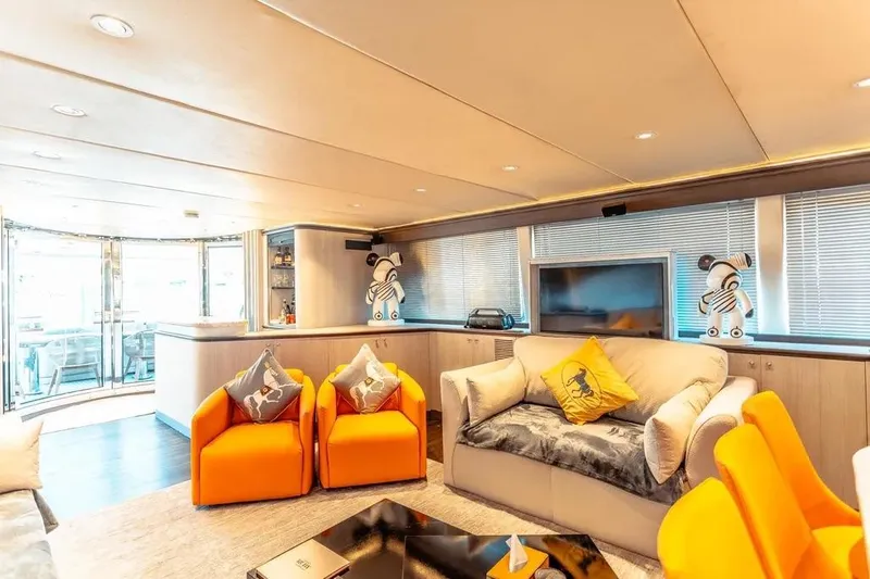  Yacht Photos Pics Luxurious interior of 2004 Azimut 100 Jumbo yacht with modern decor and vibrant seating.