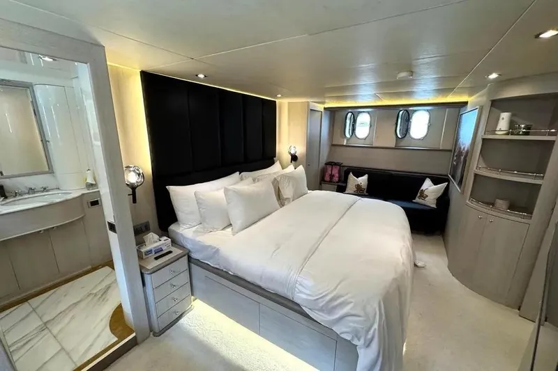  Yacht Photos Pics Luxurious bedroom interior of 2004 Azimut 100 Jumbo yacht with elegant decor and ensuite bathroom.