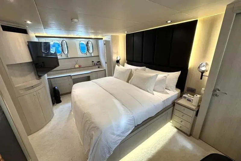  Yacht Photos Pics Luxurious bedroom interior of 2004 Azimut 100 Jumbo yacht with modern decor and ambient lighting.