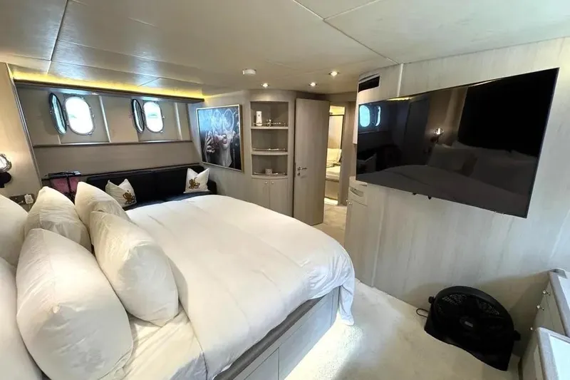  Yacht Photos Pics Luxurious bedroom interior of 2004 Azimut 100 Jumbo yacht with modern decor and large TV.