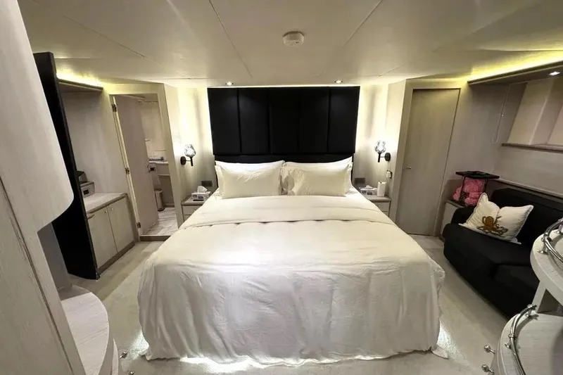  Yacht Photos Pics Luxurious bedroom interior of 2004 Azimut 100 Jumbo yacht with elegant bedding and modern decor.