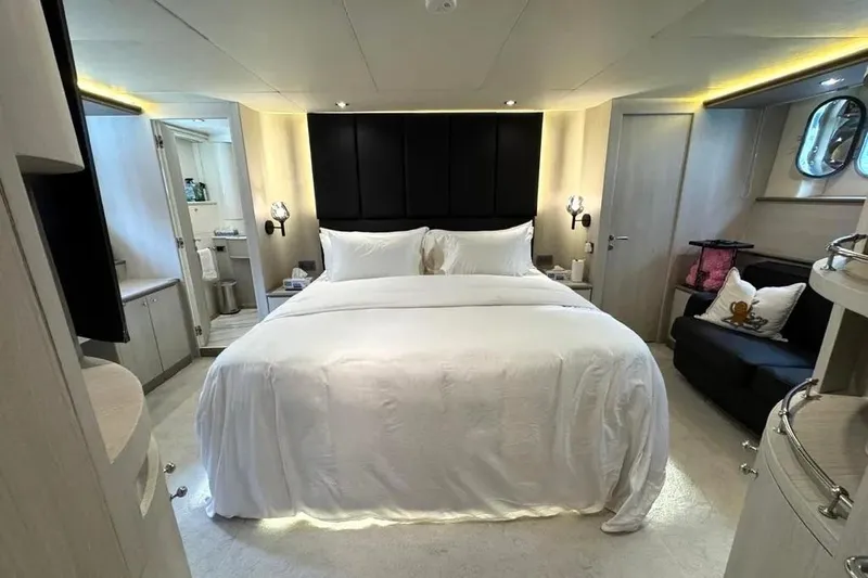  Yacht Photos Pics Luxurious bedroom interior on a 2004 Azimut 100 Jumbo yacht, featuring elegant decor and cozy bedding.