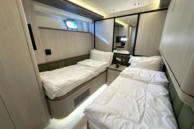  Yacht Photos Pics Luxurious twin bedroom on 2004 Azimut 100 Jumbo yacht, featuring modern decor and cozy bedding.