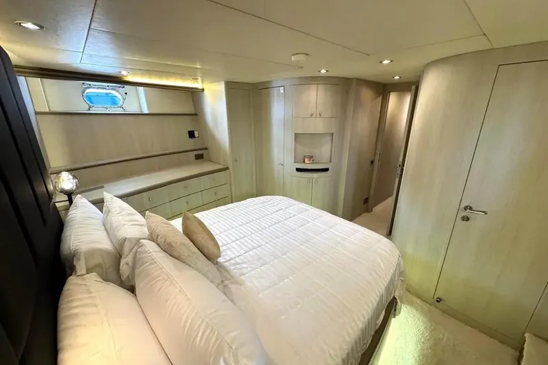  Yacht Photos Pics Luxurious bedroom interior of 2004 Azimut 100 Jumbo yacht, featuring elegant design and cozy ambiance.