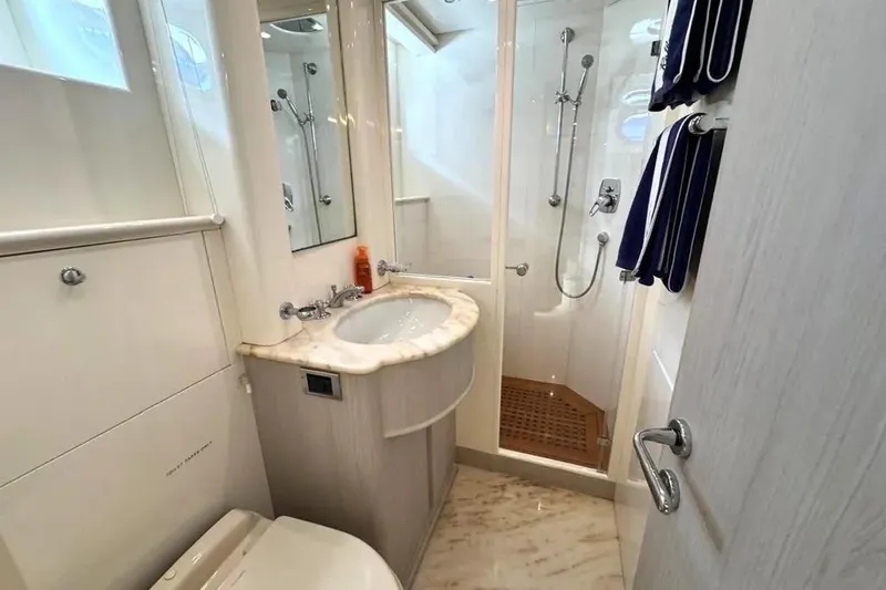  Yacht Photos Pics Luxurious bathroom on a 2004 Azimut 100 Jumbo yacht, featuring elegant fixtures and a shower.