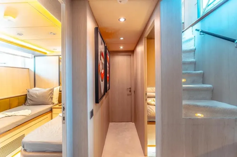  Yacht Photos Pics Luxurious interior of 2004 Azimut 100 Jumbo yacht, featuring cozy cabin and elegant staircase.