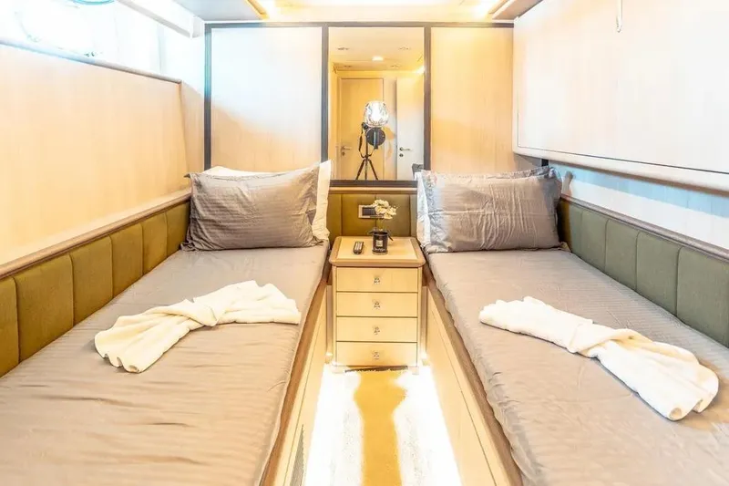  Yacht Photos Pics Luxurious twin cabin interior of 2004 Azimut 100 Jumbo yacht, featuring elegant bedding and decor.