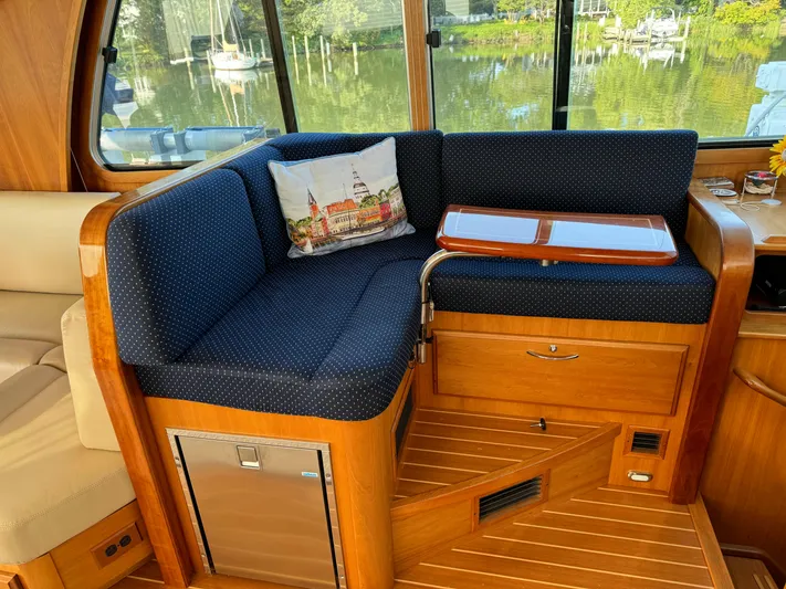 Its A Blast Yacht Photos Pics Interior of 2010 Sabre 52 Salon Express with blue seating and wooden accents.