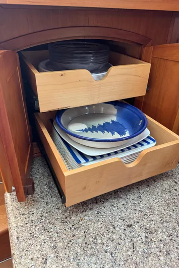 Its A Blast Yacht Photos Pics Wooden kitchen drawers with plates in a 2010 Sabre 52 Salon Express.