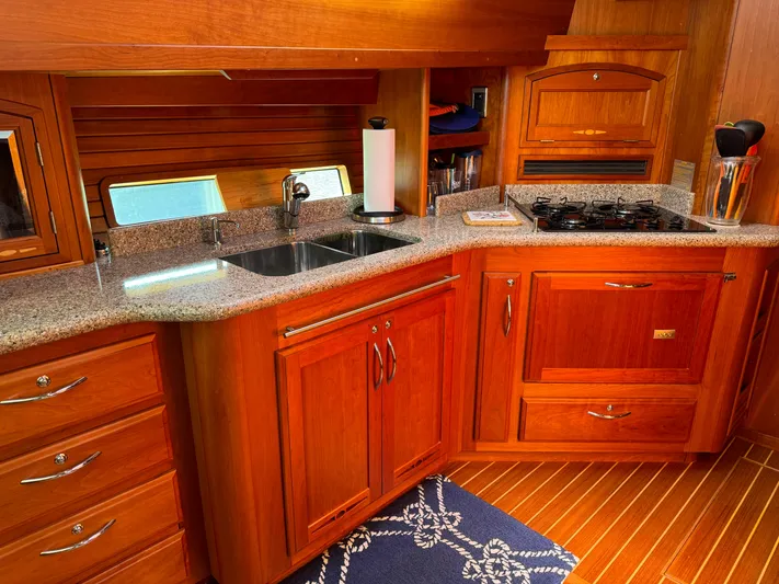 Its A Blast Yacht Photos Pics Luxurious 2010 Sabre 52 Salon Express yacht kitchen with wood cabinetry and granite countertops.