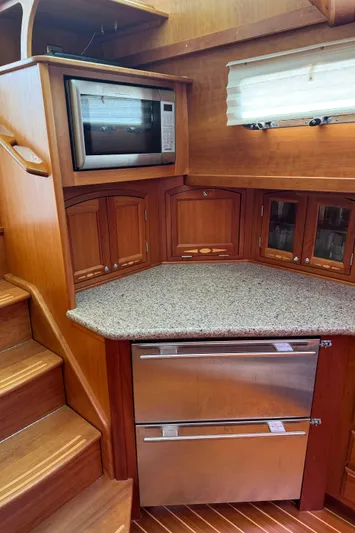 Its A Blast Yacht Photos Pics 2010 Sabre 52 Salon Express kitchen with microwave, wooden cabinets, and stainless steel drawers.