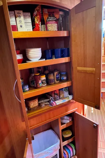 Its A Blast Yacht Photos Pics Wooden pantry with shelves, stocked with food and kitchen items on a 2010 Sabre 52 Salon Express.