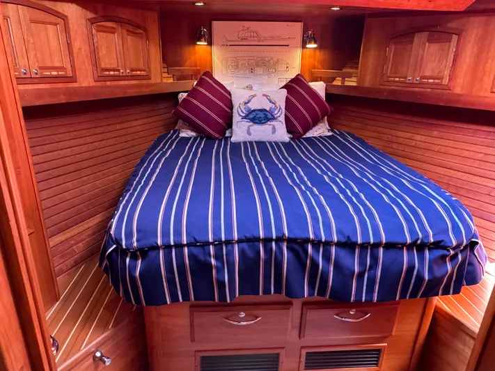 Its A Blast Yacht Photos Pics Luxurious cabin interior of 2010 Sabre 52 Salon Express with striped bedding and wooden cabinetry.