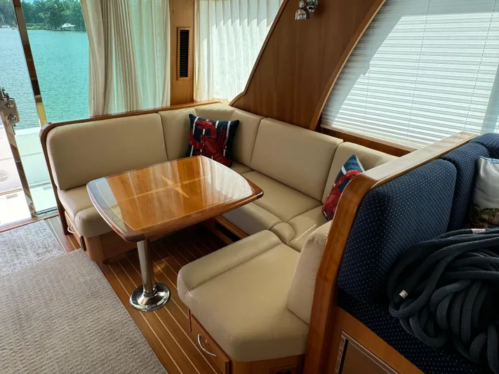 Its A Blast Yacht Photos Pics Interior of 2010 Sabre 52 Salon Express yacht with cozy seating and wooden table.