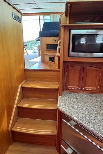 Its A Blast Yacht Photos Pics Interior of 2010 Sabre 52 Salon Express yacht with wooden stairs and kitchen area.