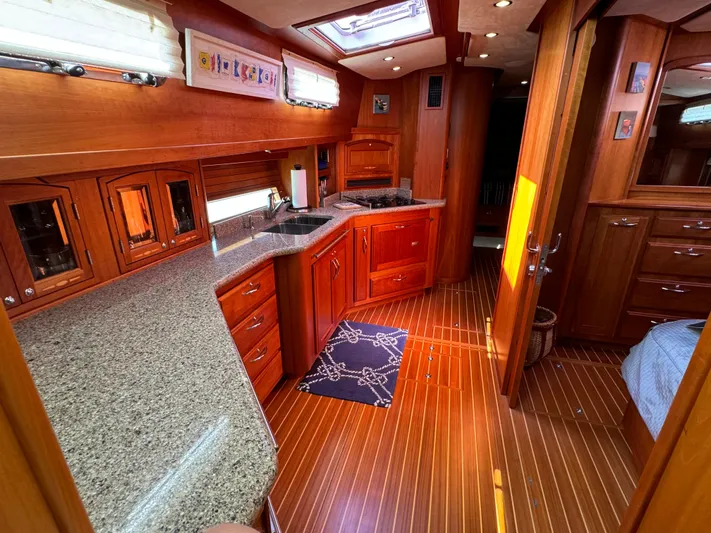 Its A Blast Yacht Photos Pics Luxurious 2010 Sabre 52 Salon Express yacht interior with wood finishes and modern kitchen.