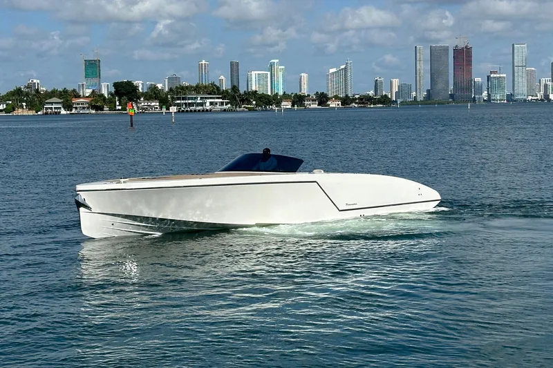 Lolo Yacht Photos Pics 2020 Frauscher 1017 GT boat cruising on water with city skyline in background.