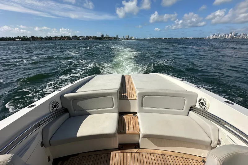 Lolo Yacht Photos Pics 2020 Frauscher 1017 GT boat cruising on open water with city skyline in background.