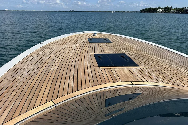 Lolo Yacht Photos Pics 2020 Frauscher 1017 GT yacht with sleek wooden deck on calm water.