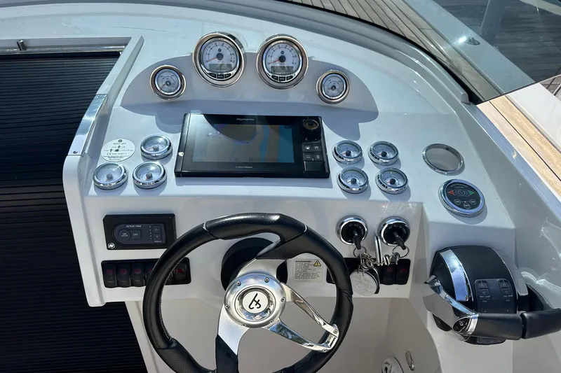 Lolo Yacht Photos Pics Dashboard of a 2020 Frauscher 1017 GT boat with steering wheel and controls.