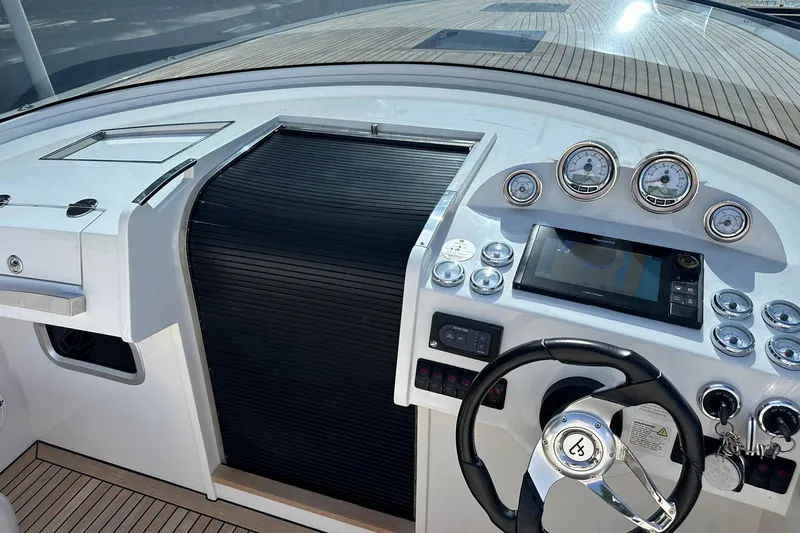 Lolo Yacht Photos Pics 2020 Frauscher 1017 GT boat dashboard with steering wheel and navigation instruments.