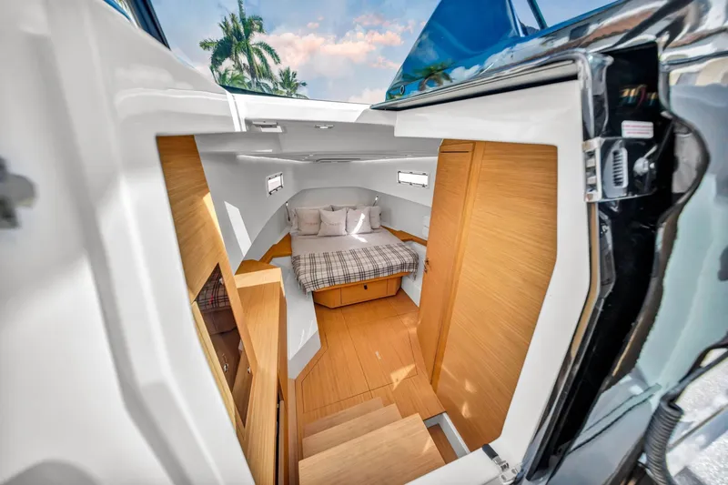 Vector 9 Yacht Photos Pics Interior cabin of 2021 Pardo Yachts 38, featuring a cozy bed and wooden finishes.