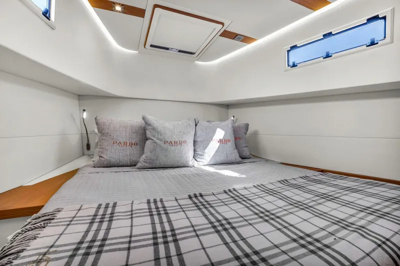 Vector 9 Yacht Photos Pics Luxurious cabin interior of 2021 Pardo Yachts 38 with cozy bedding and modern design.