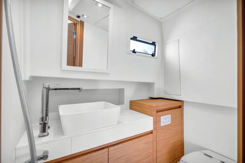 Vector 9 Yacht Photos Pics Modern bathroom interior of 2021 Pardo Yachts 38, featuring sleek sink and wooden cabinetry.