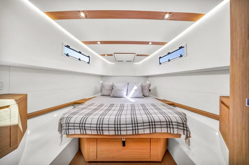 Vector 9 Yacht Photos Pics Luxurious cabin interior of 2021 Pardo Yachts 38, featuring elegant wood accents and cozy bedding.
