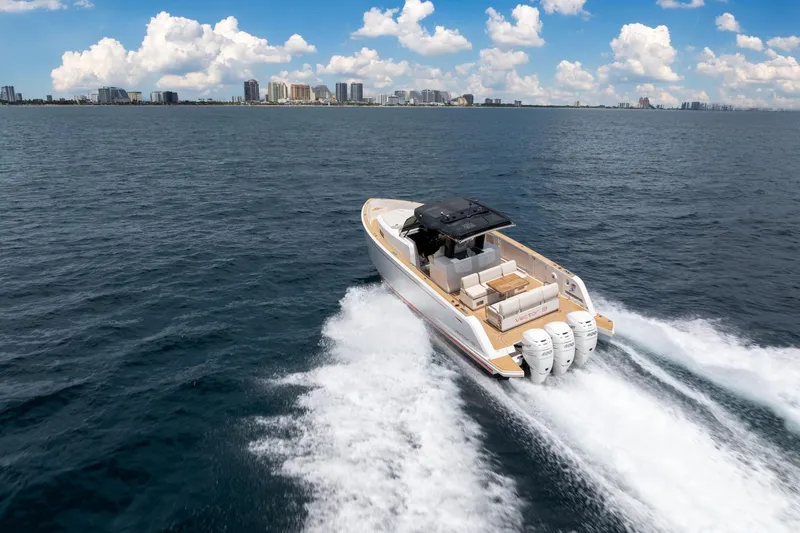 Vector 9 Yacht Photos Pics 2021 Pardo Yachts 38 cruising on open water with city skyline in background.