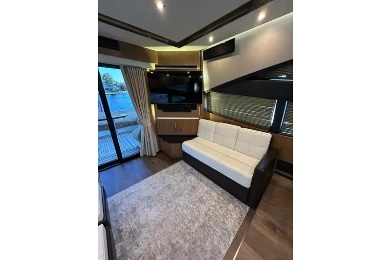 Special K Yacht Photos Pics Luxurious interior of 2016 Sea Ray L650 yacht with modern sofa and large TV.