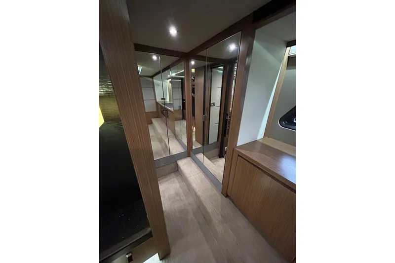 Special K Yacht Photos Pics Luxurious interior of 2016 Sea Ray L650 yacht with wood finishes and mirrored closet.
