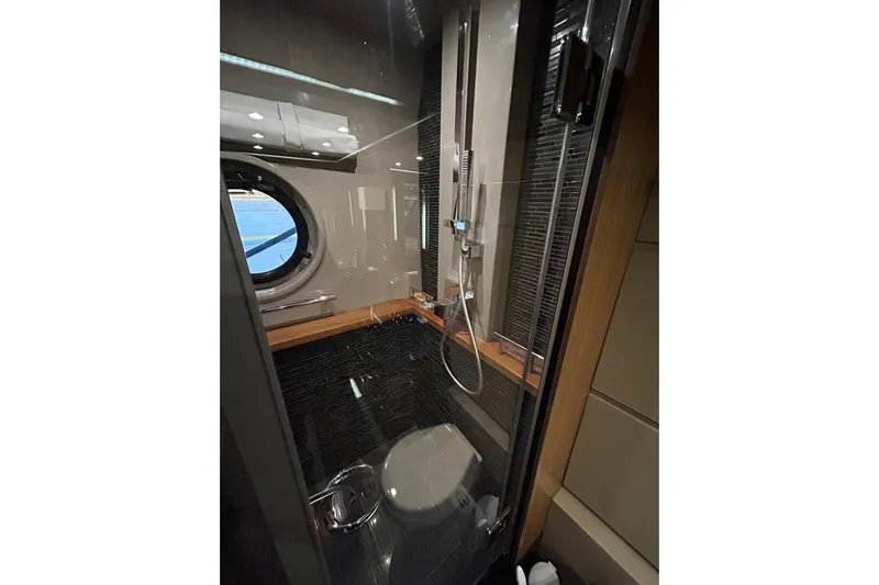 Special K Yacht Photos Pics Luxurious bathroom in 2016 Sea Ray L650 yacht with modern shower and porthole window.