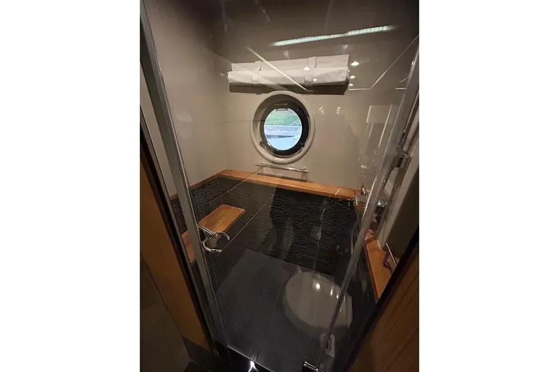 Special K Yacht Photos Pics Luxurious bathroom interior of 2016 Sea Ray L650 yacht with porthole window.