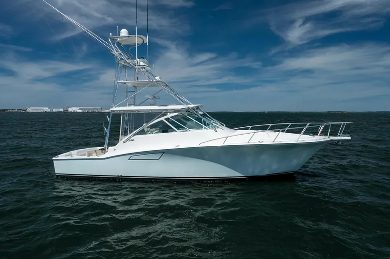 Kat's Meow Yacht Photos Pics 2004 Cabo 40 Express yacht on open water under a clear blue sky.