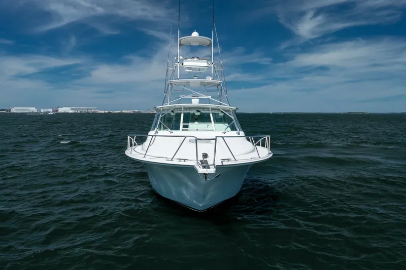 Kat's Meow Yacht Photos Pics 2004 Cabo 40 Express yacht on open water under a clear blue sky.